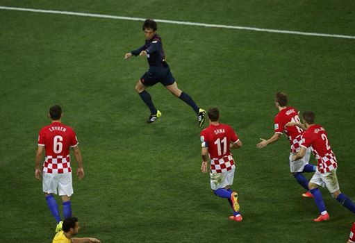 Referee Yuichi Nishimura points to the penalty spot in the 71' of Brazil's 3-1 victory over Croatia on Thursday. Will bad refereeing continue through the entire tournament? Credit: Fox Spots